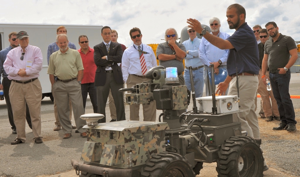 DAHLGREN, Va. (Sept. 12, 2017) - Navy scientist Jamshaid 'JD' Chaudhry briefs visitors on the Weaponized Autonomous System Prototype (WASP) after the Sly Fox Mission 22 demonstration held at Naval Surface Warfare Center Dahlgren Division. The demonstration featured the capabilities of the Collaborative Aerial Network for the Autonomous Remote Engagement System (CANARES) rapid prototyping technology developed by Mission 22 junior scientists and engineers. CANARES consists of an unmanned aerial vehicle, unmanned ground vehicle, and a command and control station.
