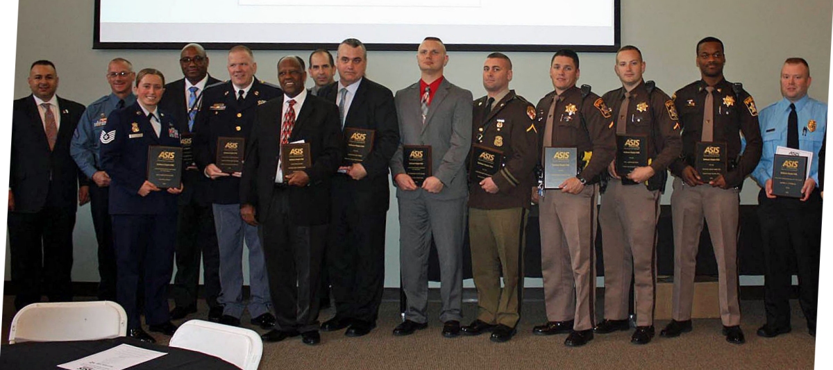 From left to right after man wearing gray suit: Trooper Milich, PFC Nauman, PFC Bottorf, Officer Hamilton. Not pictured is Cpl. Saunders and Detective Harris.