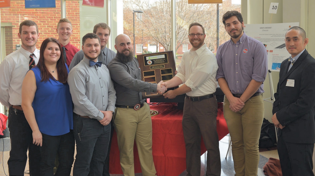 CSM alumni and members of the award-winning design team, from left, Andrew Graham of Owings, Mika Tymofiy of Mechanicsville, Mike Johnson of La Plata, Erik Bazyk of Mechanicsville, Sean Thomas of Charlotte Hall and Zachary Ball of Bryans Road are congratulated by Senior Project Manager at the Office of Sustainability Mark Stewart, Director of Sustainability for the UMD Student Government Association Willem Klajbor and Dr. Vincent Nguyen, lecturer/research associate of UMD's Department of Mechanical Engineering and one of the competition's adjudicators.