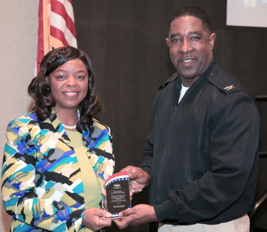DAHLGREN, Va. (March 28, 2018) --- Capt. Godfrey "Gus" Weekes, Naval Surface Warfare Center Dahlgren Division commanding officer, presents a plaque to Annie Andrews, a retired U.S. Navy rear admiral, after her keynote speech at a Women's History Month observance. Now a top official with the Federal Aviation Administration, she joined the military commands based at Naval Support Facility Dahlgren to celebrate and reflect on the theme "Honoring Women Who Fight All Forms of Discrimination." In her speech, Andrews described characteristics of successful leaders, citing examples of women in leadership who exemplified those traits. "As you continue your vital roles here at Dahlgren and throughout your careers, whether you're in uniform or out of uniform, think about what your legacies will be," said Andrews. "Many of you out there can be recognized and honored just like these pioneer women for breaking down barriers that might be standing in your way." (U.S. Navy photo by Ryan DeShazo/Released)