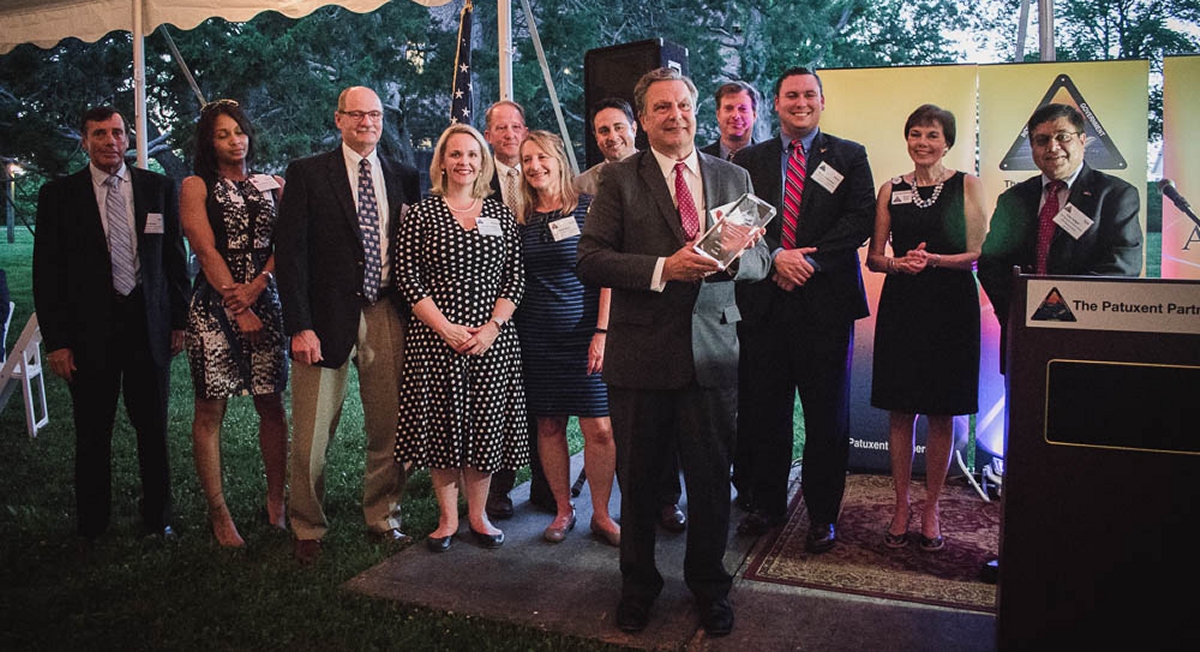 Employees of Aviation Systems Engineering Company join company president Vincent Bellezza to accept The Patuxent Partnership Member of the Year Award at the TPP annual members dinner on May 23 at Historic St. Mary's City, Maryland. (Photo by Sarah Ehman)