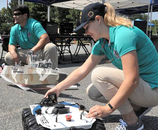 DAHLGREN (Aug. 7, 2018) - The Naval Surface Warfare Center Dahlgren Division (NSWCDD) Sly Fox Mission 23 team in action while demonstrating ARTEMIS - Autonomous Remote Tactical Engagement Multi-Domain Intelligence Swarm - capabilities. Over the past six months, the team used artificial intelligence and machine learning to develop unmanned vehicle swarms that can counteract potential threats of swarming unmanned systems. The Sly Fox program is an NSWCDD Naval Innovative Science and Engineering (NISE) funded rapid prototyping program intended to develop the science and engineering workforce - mostly junior scientists and engineers - while applying their talents to known technology gaps. NISE is part of National Defense Authorization Act Section 219 legislation, allowing warfare centers and research labs to apply money invested in their organizations to research, engineering and technology. NISE efforts have provided breakthrough research and have been responsible for maturation and transition of technology to the warfighter and programs of record.