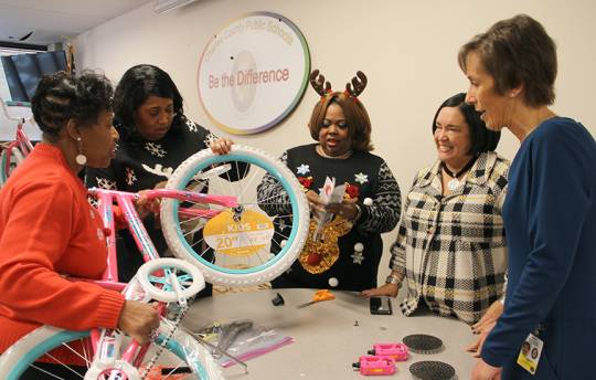 Elementary school principals Verniece Rorie of Gale-Bailey, Orlena Whatley of Dr. Samuel A. Mudd and Sabrina Robinson-Taylor of Walter J. Mitchell keep working while talking with Kelly Caplan of Washington Gas and Superintendent Kimberly A. Hill.