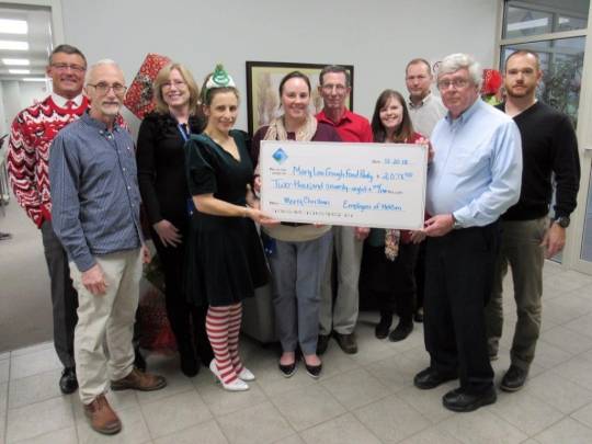 Employees of the Metropolitan Commission present a $2,078 donation to Mary Lou Gough Food Pantry representative Dennis Cantwell. (Submitted photo)