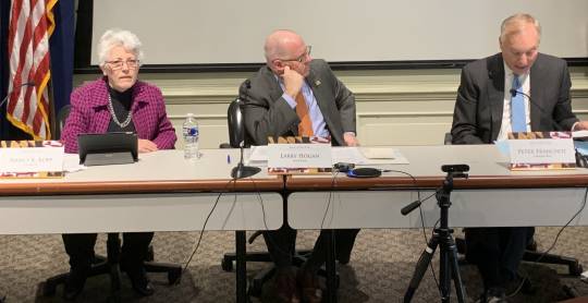 Treasurer Nancy Kopp, Gov. Larry Hogan, center, and Comptroller Peter Franchot at the Board of Public Works meeting on March 4, 2020, in Annapolis, Maryland. The panel approved $2.9 million each in compensation for three men wrongfully imprisoned more than 30 years ago in a middle-school killing over a Georgetown jacket. (Kevin Brown)
