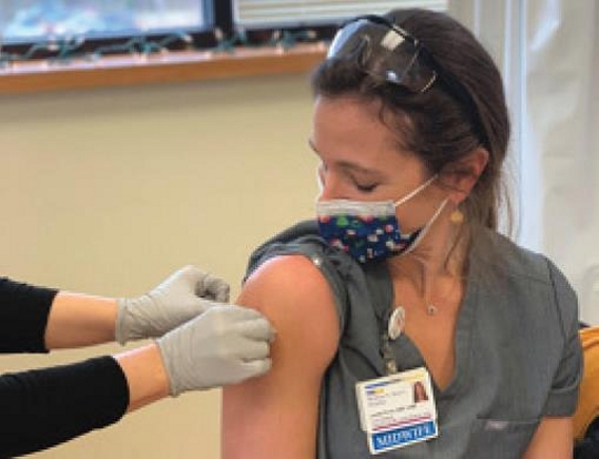 Lauren Ervin, DNP, CNMI, a midwife with MedStar Medical Group Women’s Health at Leonardtown gets a band aid after receiving the COVID-19 vaccine. (Photo: The County Times)