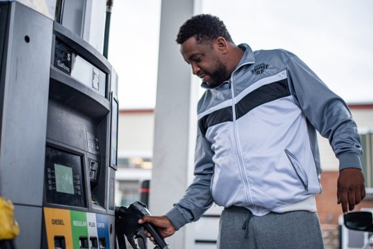 Darrell Lee, after filling his tank in west Baltimore in preparation for a DoorDash delivery, said the economy needs long-term solutions and not a temporary stop gap. (Photo: Joe Ryan)