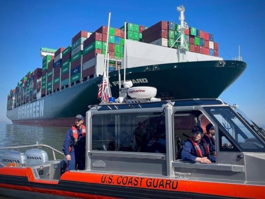 Capt. David O'Connell, the sector commander of Coast Guard Sector Maryland - National Capital Region, and crew members from Coast Guard Station Curtis Bay monitor the grounded vessel, the Ever Forward, Wednesday, March 16, 2022, in the Chesapeake Bay. The Coast Guard and the Maryland Department of the Environment are working to develop a plan to safely refloat the 1,095 foot ship carrying 4,964 containers of general dry goods. (U.S. Coast Guard photo by Petty Officer 3rd Class Breanna Centeno/Released.)