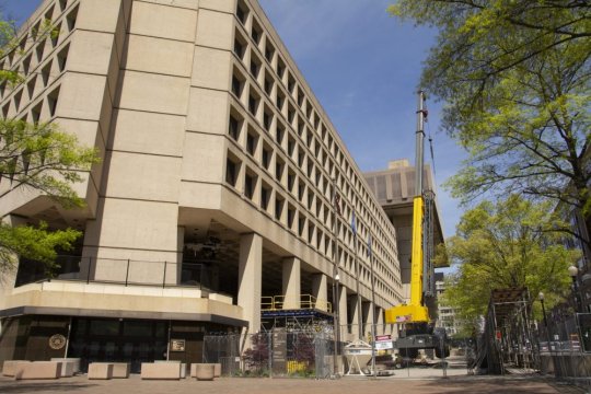 Repair crews work on the FBI's aging headquarters building in downtown Washington. The Congress and Biden administration plan to move the headquarters to one of three possible suburban sites, two of which are in Maryland. (Photo: Emily Hahn)