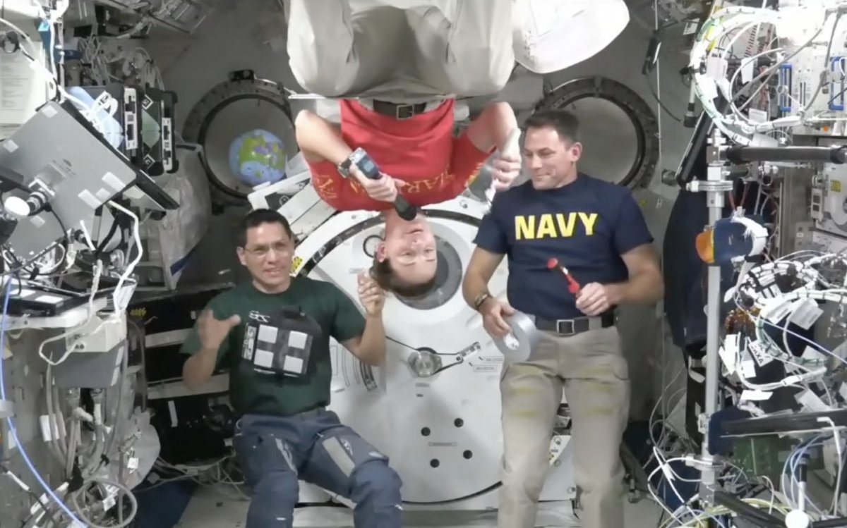 Astronauts (from left to right) Frank Rubio, Nicole A. Mann and Josh Cassada demonstrate the importance of Velcro  aboard the International Space Station as they answer questions from Maryland students and students at the U.S. Naval Test Pilot School. (Screenshot from NASA Television by Destiny Herbers)
