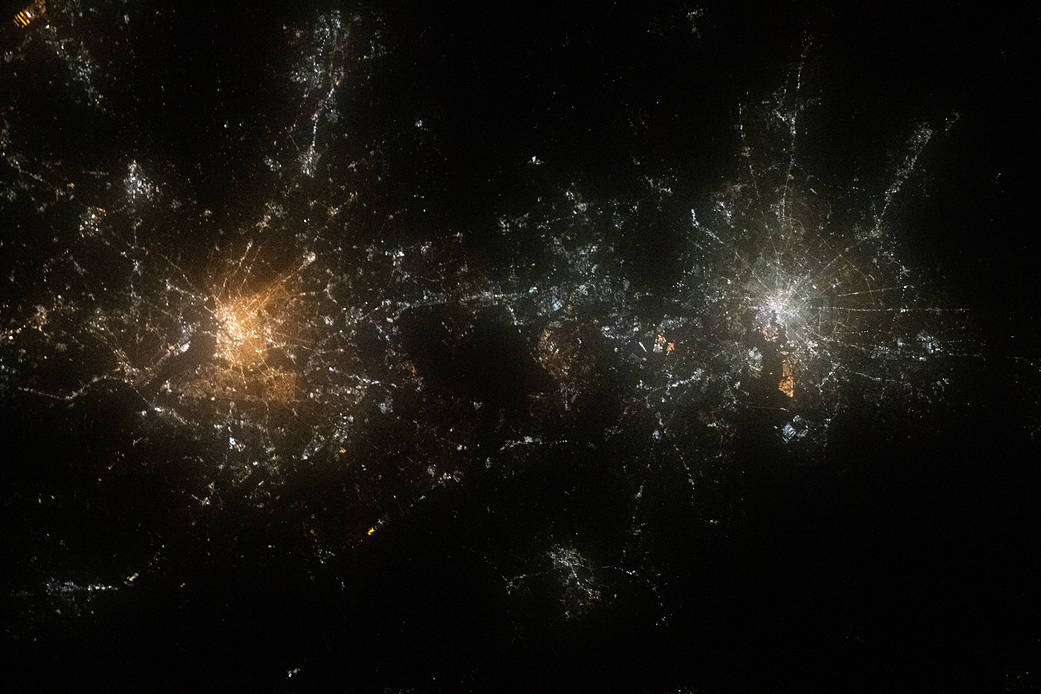 WASHINGTON --- A nighttime shot from the International Space Station in 2020 shows the well-lit cities of Washington, D.C. (left), Baltimore, Maryland (right), and their surrounding suburbs. (Photo courtesy of NASA)