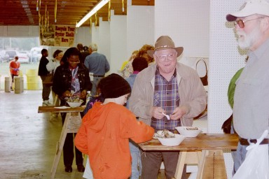These gentlemen, old and young, enjoy scalded oysters.